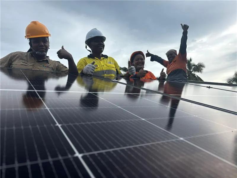 Pacific Sun Solar install crew in Fiji giving thumbs up behind a freshly mounted solar array